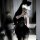 Woman wearing black lace cami dress with built-in pads, part of sexy nightclub sleepwear set with matching lingerie.