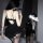 Woman wearing black lace cami dress with built-in pads, matching lingerie set, sheer stockings, and cutout back design — perf...