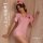 Woman in pink nurse costume with red crosses, posing seductively for role play and adult fun.