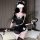 Woman in sexy nurse-maid lingerie set with apron, holding whip, for adult role play.