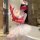 Woman in sexy nurse costume with lace bodice, red gloves, white tutu skirt, and nurse hat for halloween or cosplay.