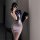 Woman in sexy office secretary costume set, sleeveless sheath dress with lanyard and clipboard, posing for mirror selfie.