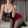 Woman in black lingerie top and red bodycon skirt with sheer stockings, posing on bed — sexy ol secretary costume set for wom...
