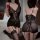 Woman modeling black lace bodysuit with deep v-neck, open crotch, and elastic straps. includes matching garter stockings.