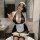 Woman in black lace maid costume with white apron and headpiece, posing seductively in bathroom.