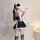 Woman in black plus size maid costume with lace trim, white apron, and headpiece, posing seductively for mirror selfie.