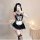 Woman in black and white maid costume with lace trim, corset top, apron, thigh-high stockings, and headpiece — sexy plus size...