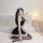 Woman in black plus size maid costume with lace trim, posing on white rug. seductive lingerie sleepwear outfit for women.