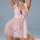 Woman wearing pink sheer polka dot babydoll nightgown with lace trim, adjustable straps, and backless design.