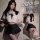 Woman modeling a white crop top and black ultra-short skirt with fishnet stockings, showcasing the sexy pure-temptation unifo...