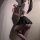Woman in sexy pure-temptation uniform set: ultra-short black skirt, white crop top, fishnet stockings — jk style lingerie.
