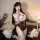 Woman wearing a sexy role play lingerie set, featuring a sheer backless maid costume with lace details and thigh-high stockin...