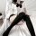 Woman wearing sexy sailor outfit lingerie set with black bow, sheer thigh-high socks, and cute schoolgirl jk uniform style.