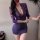 Woman wearing a purple deep v lace bodysuit dress with sheer mesh sleeves and a mini skirt silhouette.