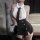 Woman wearing sexy secretary costume set with sheer white top, black tie, and matching skirt for role play lingerie.