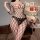 Woman modeling a black sheer mesh bodysuit with fishnet pattern and open-crotch design, part of the sexy secretary costume se...