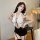 Woman modeling white halter top with black mini skirt and garter straps, part of the sexy secretary ol costume set for role p...