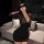 Woman in black lace bodycon dress with deep v-neck, styled as a sexy secretary ol outfit for role play or date night.