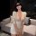 Woman wearing a white bodycon dress with lace sleeves and a matching lingerie set, perfect for role play or date night.