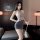 Woman modeling a sexy secretary outfit set with sheer lingerie skirt and matching sleepwear for tempting allure.