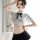 Woman modeling white sheer jk uniform shirt with black bow and pleated skirt, college style no-remove design.