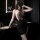 Woman in a sexy sheer halter bodycon dress, styled as seductive no-remove sleepwear, posing elegantly in a modern bathroom se...