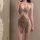Woman wearing a sparkling sheer lace halter mini dress, perfect for nightclub outings and alluring party wear.
