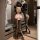 Woman wearing sexy sheer lace sleepwear set with open-crotch bodysuit and matching lingerie, shown in mirror reflection.