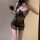 Woman modeling sheer polka dot lace chemise with black butterfly bow and bodycon fit, holding feather accessory.