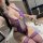 Woman wearing purple lace bodysuit and thigh-highs, holding roses. sheer sm lingerie set for small bust & plus size.