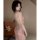 Woman wearing a shiny pink backless sleep dress with sheer detailing, perfect for nightlife or provocative loungewear.