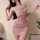 Woman wearing a sexy shiny pink nightclub lingerie sleep dress with sheer backless design.