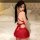 Woman wearing a red pleated jk uniform set with bells, featuring a short skirt and backless top, ideal for premium adult cost...