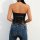 Woman wearing glossy black pvc halter bodysuit with side ties and backless design, paired with blue jeans.
