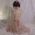 Woman in pink lace cami and matching briefs, elegant back bow detail, soft fabric, romantic bedroom lingerie set.