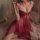 Woman wearing a sheer red split chemise with lace detailing, part of a sexy sleepwear set for women.