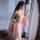 A woman wears a delicate pink hanfu-inspired sleepwear set featuring an open-crotch design, combining elegance with tradition...