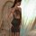 Woman wearing a sexy sparkle halter nightclub bodycon dress, featuring a seductive secretary style with a shimmering skirt an...