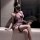 Woman in sexy vintage lace cheongsam lingerie set with sheer see-through sleepwear and retro erotic nightgown outfit, holding...