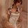 Woman wearing a sexy vintage qipao lingerie set with side-tie straps, featuring retro chinese-inspired design.