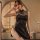Woman modeling black vintage qipao lingerie with side-tie straps and sheer neckline in retro chinese-inspired style.