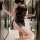 Woman wearing black vintage qipao lingerie with side-tie details in a modern bathroom setting.