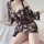 Woman wearing a sheer floral chiffon sleep dress, styled as a sexy babydoll nightgown with lace details and a seductive linge...