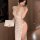 Woman wearing sheer lace deep v plunge lingerie with high-waist slit and push-up design, holding a book indoors.