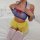 Sheer lace maid costume for women featuring a transparent top with blue trim and red bow, yellow tutu skirt, white stockings,...