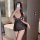Woman wearing black sheer lace sleepwear set with transparent mesh, posing in bathroom mirror selfie.