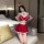 A woman poses in a festive red and white christmas-themed lingerie set, featuring cherries and a santa hat, perfect for holid...