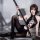 A stylish model showcases a black bodysuit set featuring lace detailing, adjustable chain straps, and a backless cutout desig...