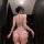 Woman wearing shuyao sensual lace bodysuit, sheer mesh tight-fit lingerie with ruffled hips and backless design.