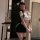 Woman wearing shuyao sexy ol secretary lingerie set with white top, black skirt, and cat ears, posing in a modern room.